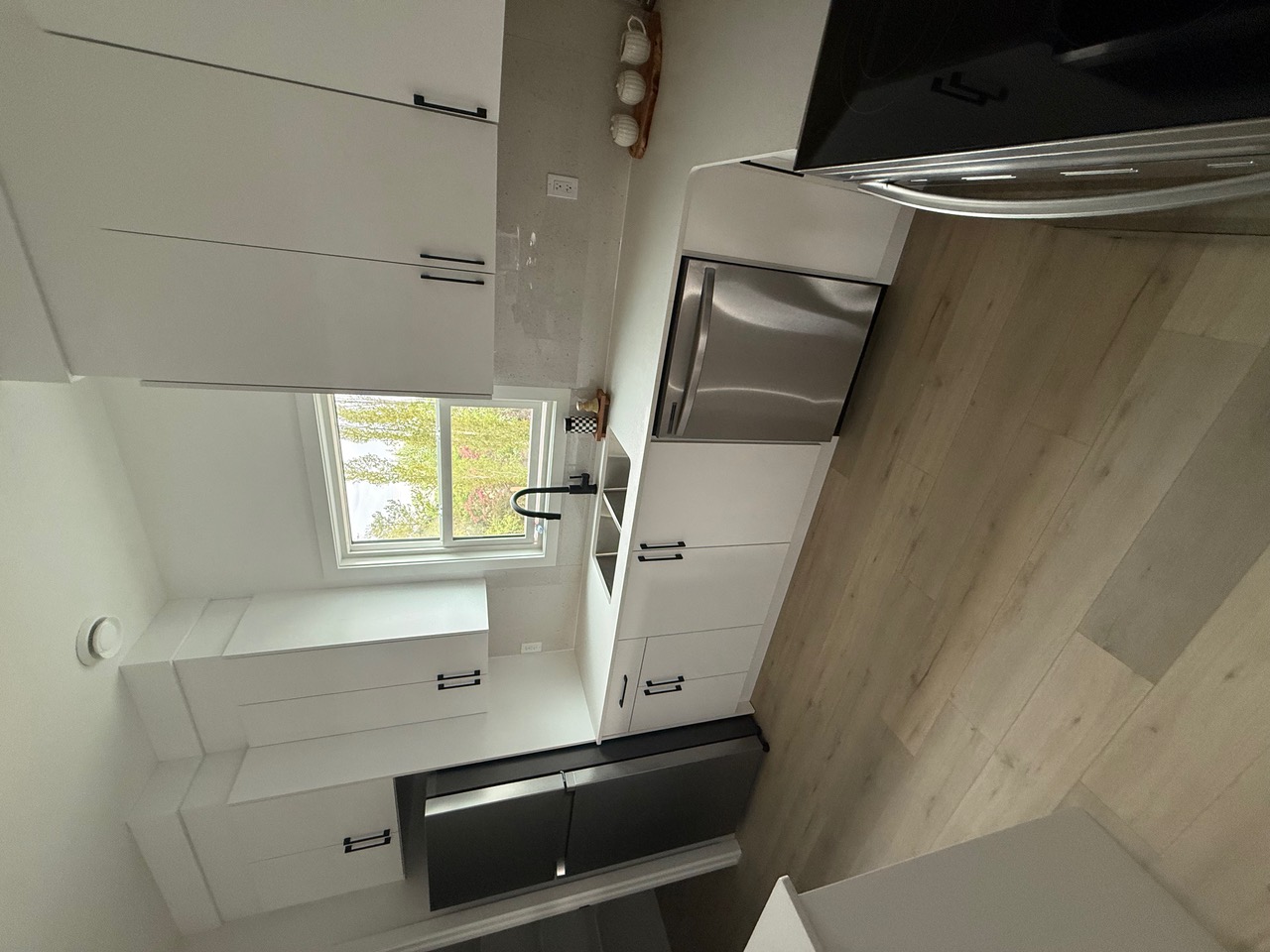 White kitchen showing flooring installation